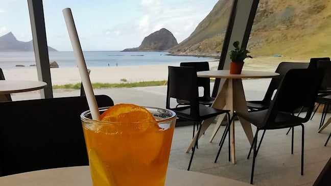 Cafe with a view of the sandy beach and mountains.