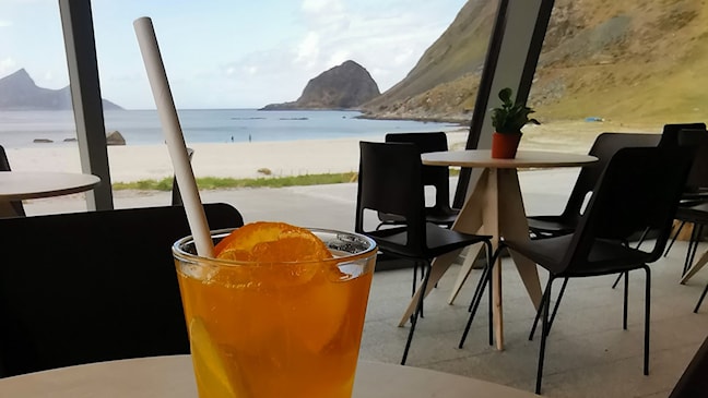 Cafe with a view of the sandy beach and mountains.