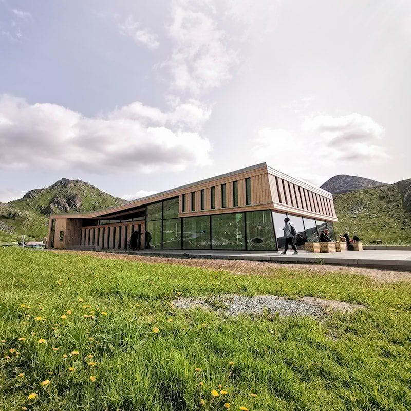 Large wooden building with glass facades.