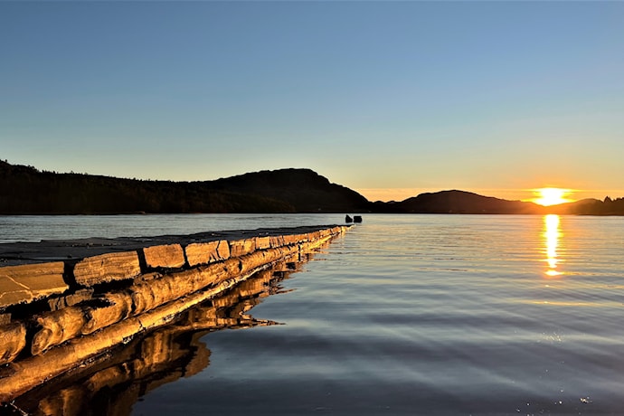 The stone jetty extends 65 metres from the beach .