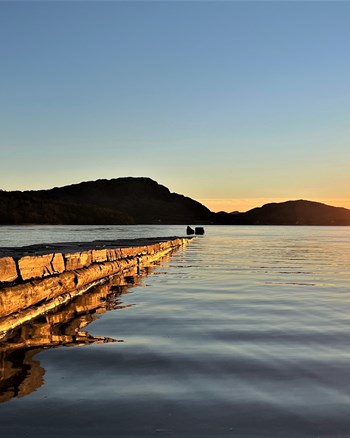 The stone jetty extends 65 metres from the beach .