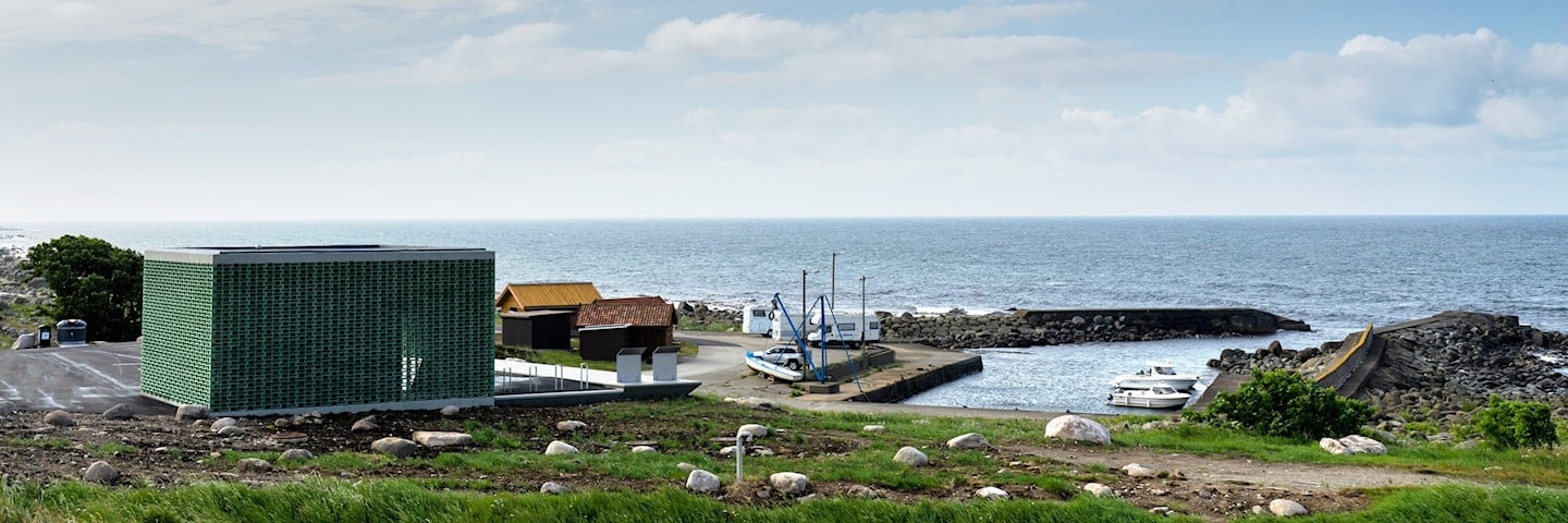 Utsikt over havna med servicebygg og stormhytter.